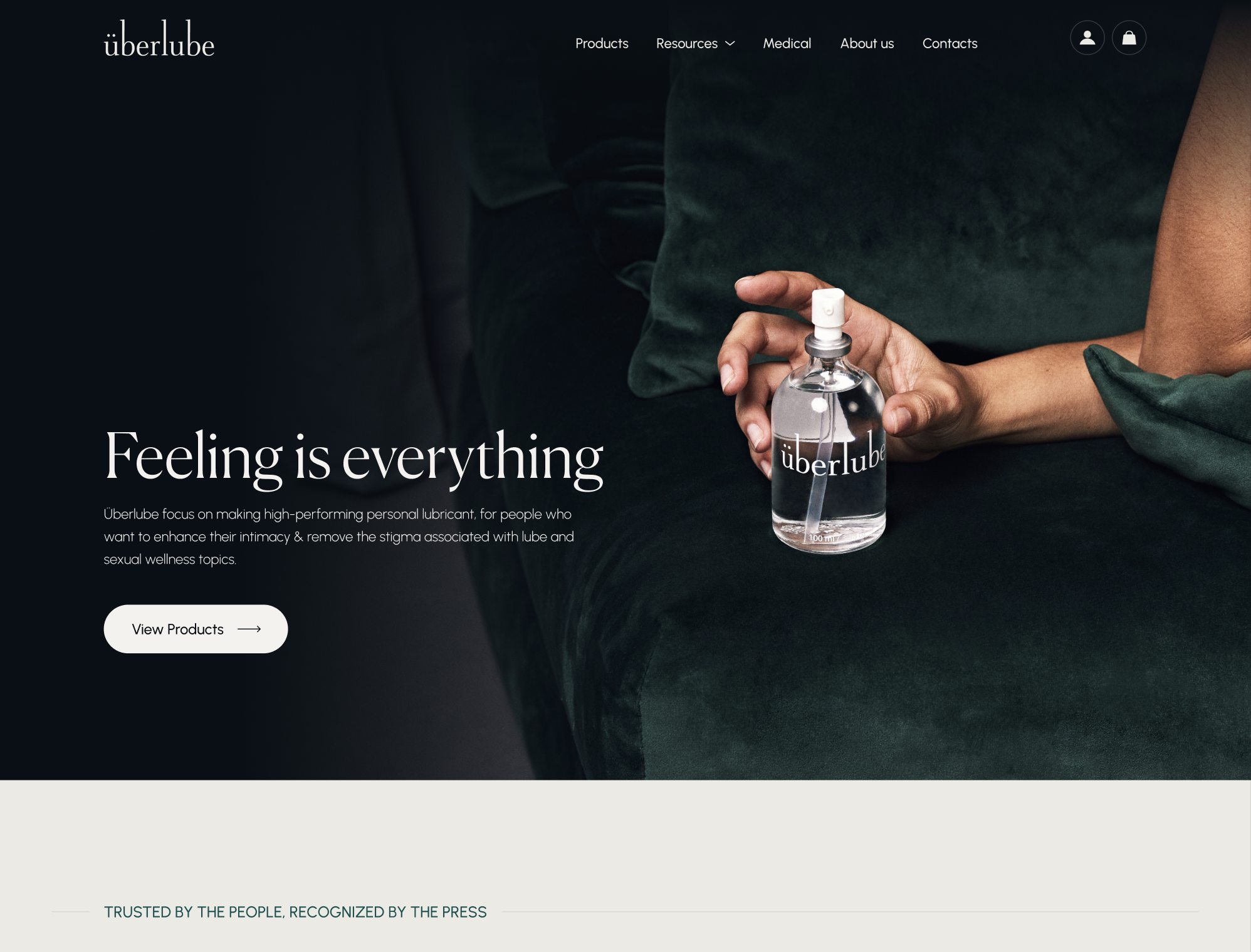 Überlube homepage concept — Feeling is everything, with the bottle held on deep green velvet